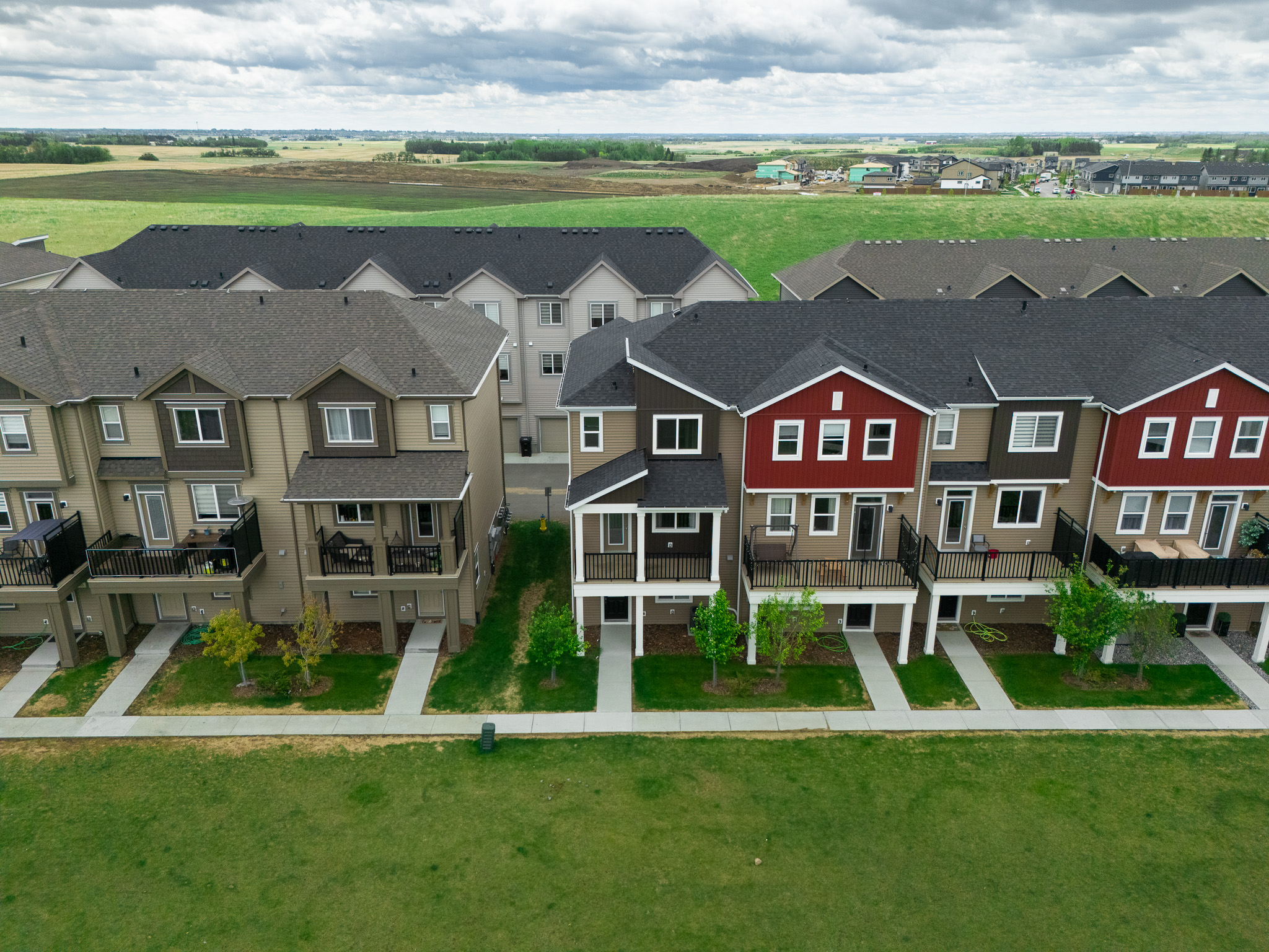 Aerial view of modern Edmonton townhomes at the edge of the city